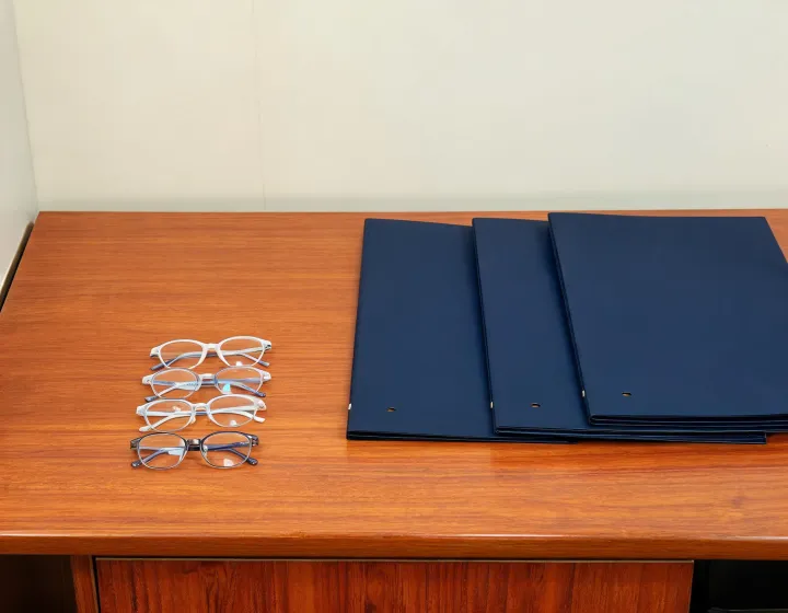 Kids glasses prescription brief beside factory quote folders